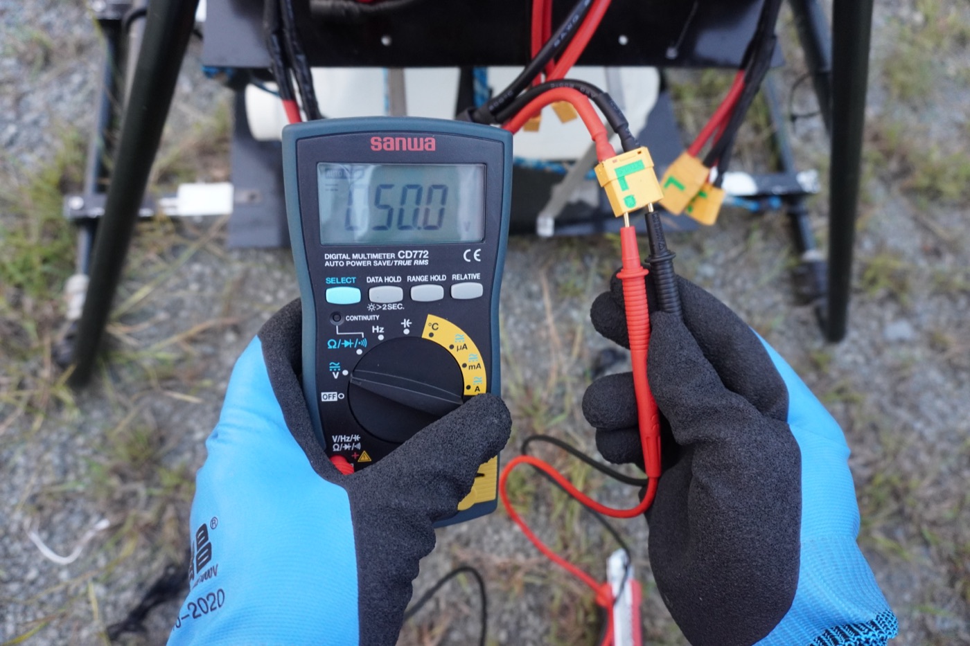 Technician measuring tether power voltage before flight